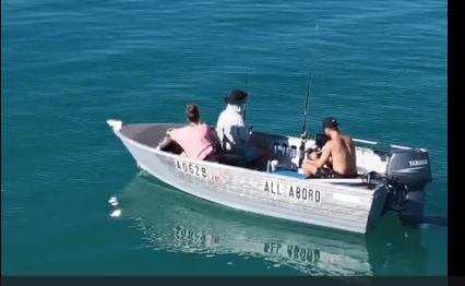 Monkey Mia Boat Hire | Self-Drive Boats in Shark Bay Three people fishing from the "All Abord" tinny boat on calm, turquoise waters in Shark Bay. Monkey Mia Boat Hire Shark Bay vessel.